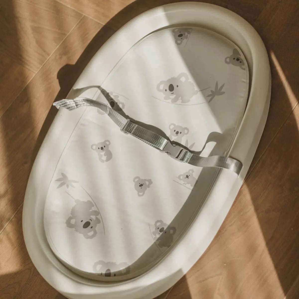 Cuddobaby changing pad with koala-pattern newborn pad and safety belt